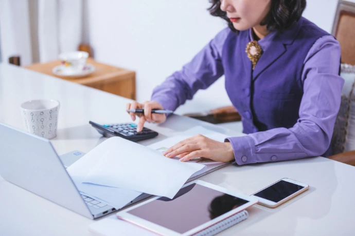 Woman accounting on sheets of paper